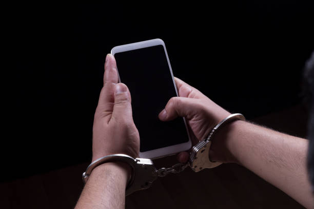 A man handcuffed to the telephone. Telephone, Smart Phone, Addiction, Handcuffs, handcuffed smart phone technology lifestyles chain stock pictures, royalty-free photos & images