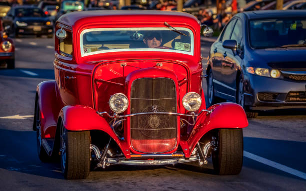 1932 Ford Deuce coupe hot rod Moncton, New Brunswick, Canada - July 8, 2017 : During 2017 Atlantic Nationals Automotive Extravaganza a man cruises in his 1932 Ford Deuce coupe hot rod, Saturday evening on Mountain Road. cruising hot rods stock pictures, royalty-free photos & images