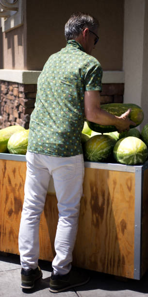 Senior Man Shopping for a Watermelon