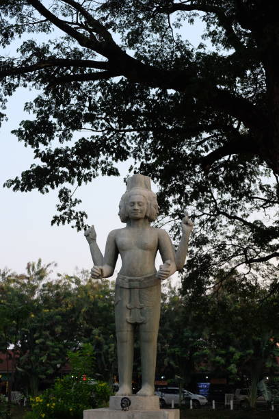 istock Sculpture of a four-armed Hindu deity. Mythical creature with four faces. 1183462711