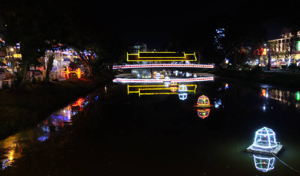 istock Decorated with decorative lights, the bridge is thrown across a small river. Night time. 1183462758