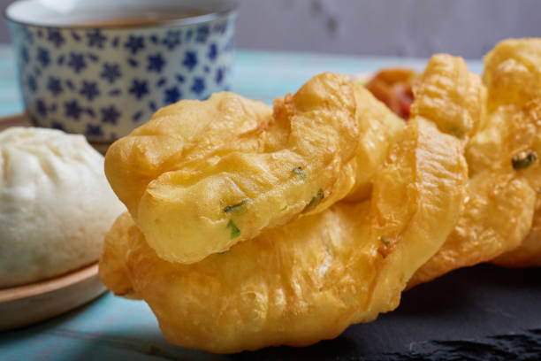 istock Chinese deep-fried dough stick on a black rock plate with steamed buns and soup 1183465574