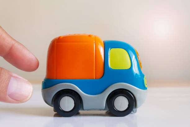 istock hand pushing a toy truck 1183469757