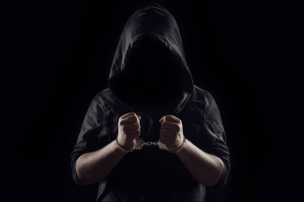 Silhouette of handcuffed male in hoodie, dangerous criminal punished by law Adult, Adults Only, Arrest, black background, hacker serial killings photos stock pictures, royalty-free photos & images