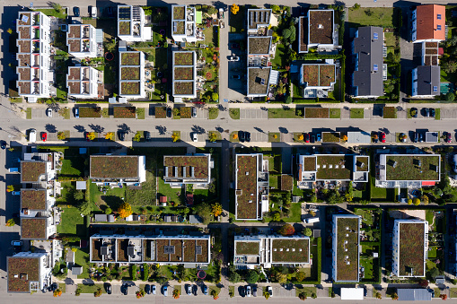 Modern housing development with houses and apartment buildings viewed from above.