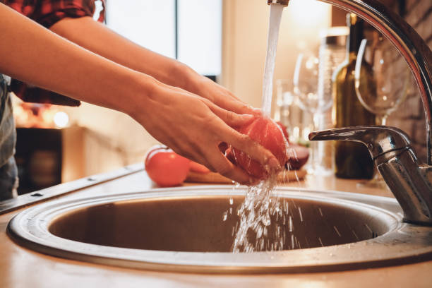 istock Hygiene rules. Wash vegetables and fruits before eating 1183472351