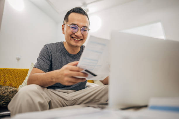 istock Man holding credit card 1183475479