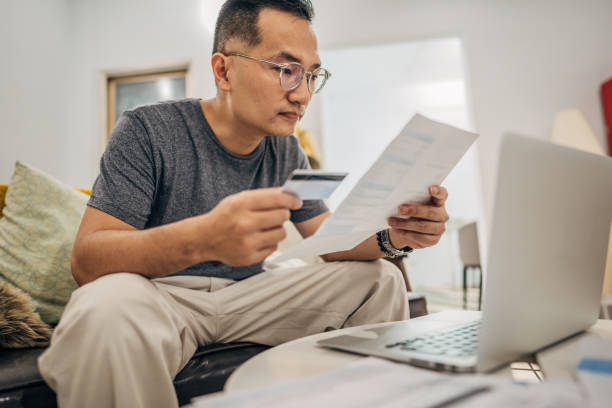 istock Man holding credit card 1183475485
