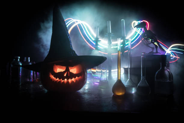 istock Halloween still-life background with different elements on dark toned foggy background. Selective focus 1183477478
