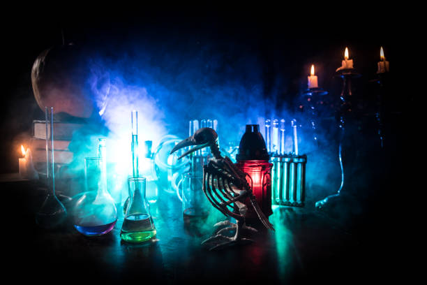 istock Halloween still-life background with different elements on dark toned foggy background. Selective focus 1183477479