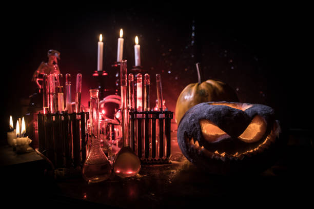istock Halloween still-life background with different elements on dark toned foggy background. Selective focus 1183477489