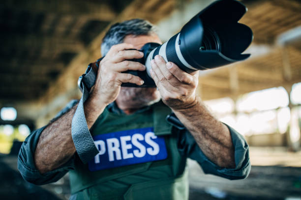 istock Journalist making reportage from the war zone 1183478718