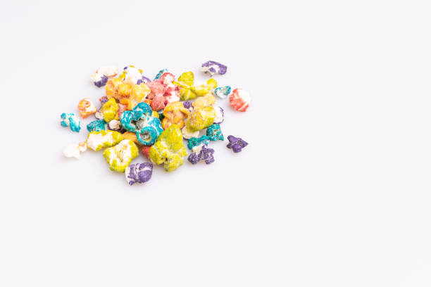 istock Colored Popcorn candy isolated on white background, soft light, studio shot, copy space. Junk food, fruit flavored popcorn. Colorful, multicolor, candy coated popcorn 1183478757
