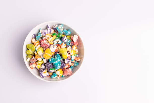 istock Colored Popcorn candy isolated on white background, soft light, studio shot, copy space. Junk food, fruit flavored popcorn. Colorful, multicolor, candy coated popcorn 1183479266
