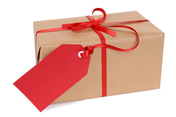 Brown paper package with red ribbon and tag