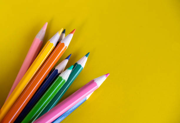 istock Colorful drawing pencils on yellow background 1183487580