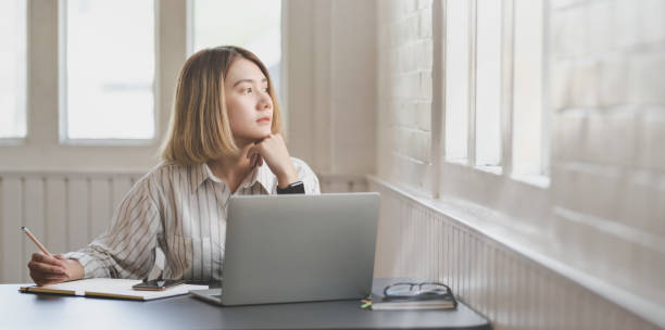 istock Young businesswoman working on her project and writing on notebook 1183501587