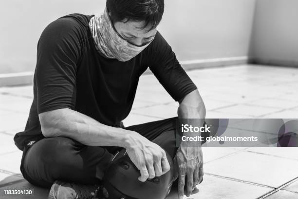 Asian Man Sitting On The Street Discouraged And Tired Stock Photo - Download Image Now