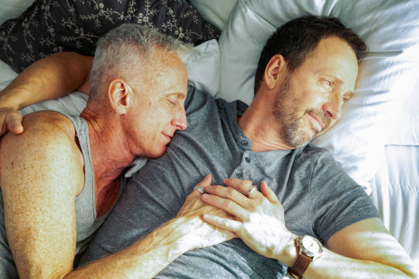 istock Senior gay couple being affectionate in bed on weekend afternoon 1183506179