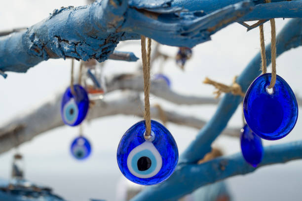 istock Stone in the form of a blue eye on the tree. 1183506433