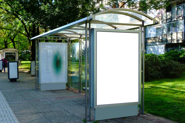 image collage of bus shelter at a bus stop of glass and aluminum frame image collage of bus shelter at a bus stop of glass and aluminum frame structure in park setting with green background and safety glass design. metal benches and white poster ad display glass & banner bus shelter stock pictures, royalty-free photos & images