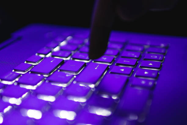 istock finger pressing the enter key on the keyboard in the dark. 1183510268