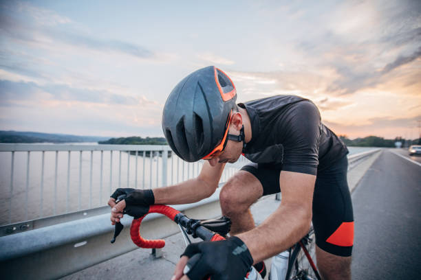 istock Athlete riding bicycle on the road 1183511854