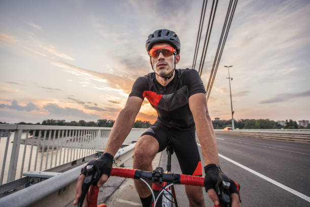 istock Athlete riding bicycle on the road 1183511878