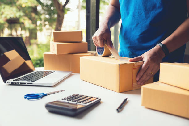 istock Man worker delivery service and working packing box, business owner working checking order to confirm before sending customer in post , Shipment Online Sales 1183514197