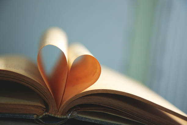 istock Book page in heart shape with old paper. 1183514501