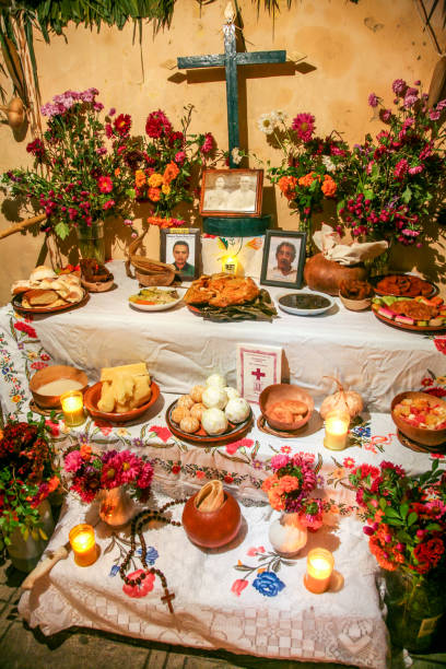 An altar with offerings to the deceased during traditional Dia de Muertos celebrations in Yucatan in southern Mexico Merida, Mexico, oct 31 - A traditional "ofrenda", an offering dedicated to the dead with numerous religious images and spiritual symbols during the celebrations of the Day of the Dead, in Merida, Yucatan, in south-eastern Mexico. altar stock pictures, royalty-free photos & images