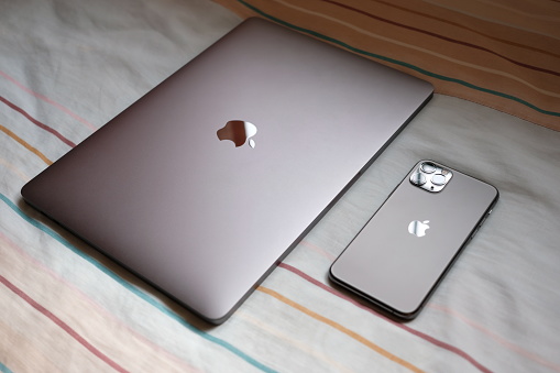 Trang,Thailand. October 25, 2019 : Customer lay down new macbook pro 2019 and iphone 11 pro are space grey colors on bed after receive from the apple store