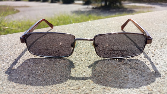 Sunglasses On A Concrete Slab With Shadows