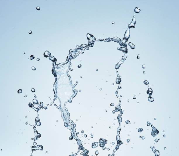istock Splashing water with blue background 1183526763
