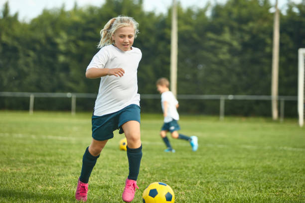 istock Young Spanish Female Footballer Practicing Dribbling 1183526823