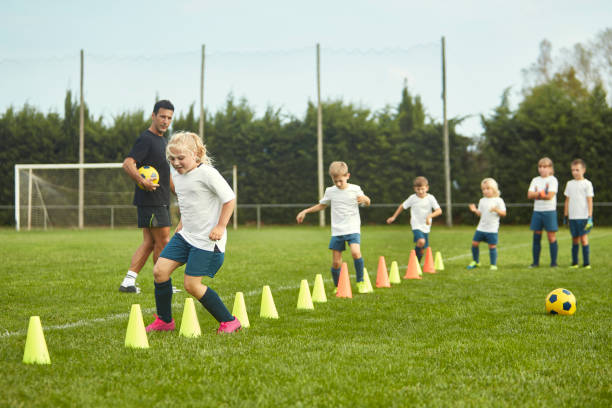 istock Young Spanish Footballers Doing Running Drills with Cones 1183526832