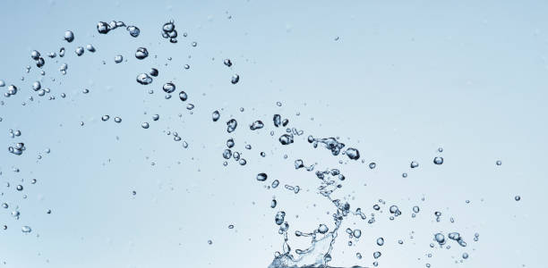 istock Splashing water with blue background 1183527060