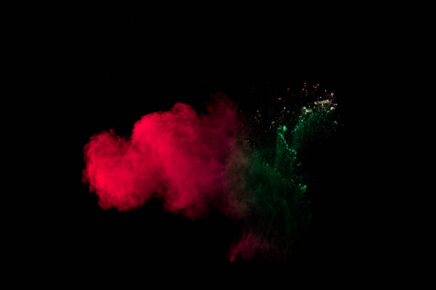 istock Colorful powder explosion on black background. Red green dust splash. 1183528429