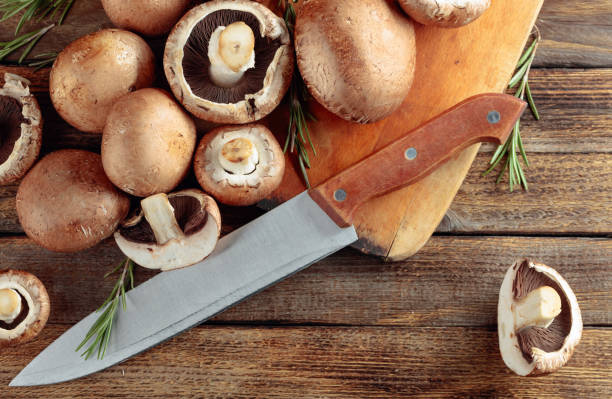 istock Fresh mushrooms mushroom on an old wooden table. 1183530996