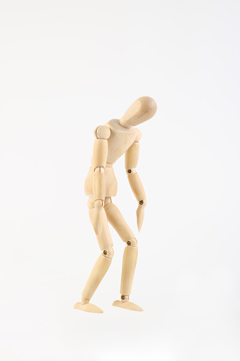 Sad wooden human mannequin on white background