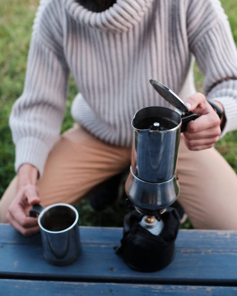 istock young man pours coffee from a geyser coffee maker 1183533362
