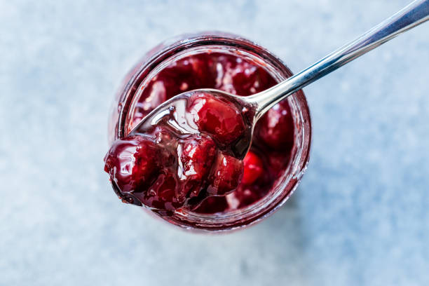 istock Cranberry Jam in Jar with Spoon / Cranberries Marmalade served with Bread Slices. 1183533482