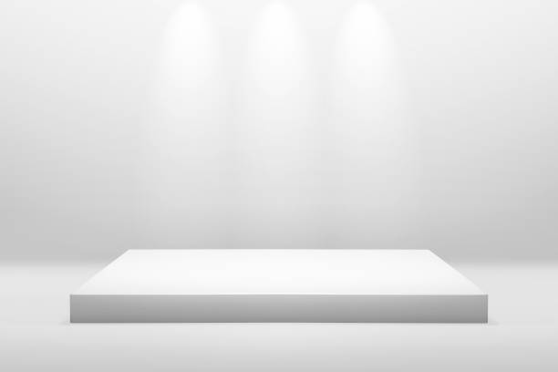 White podium stand for showing or presentation concept on modern room background with illuminate light. Empty counter shelf and product backdrops.