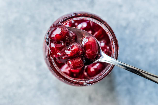 istock Cranberry Jam in Jar with Spoon / Cranberries Marmalade served with Bread Slices. 1183535876