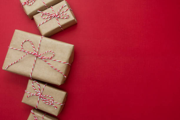 istock Craft gift boxes over red background. Christmas mockup with copy space. winter holidays with presents, top view, flat lay. 1183536021