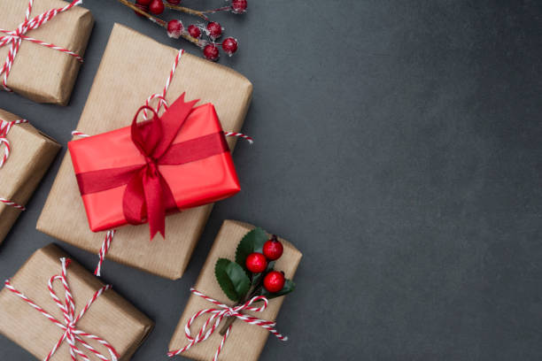 istock Craft gift boxes over dark background. Christmas mock up with copy space. Winter holidays with presents, top view, flat lay. 1183536167