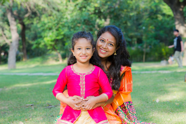 Spending time with mother stock photo Public Park, Mother, Child, Indian, South, south indian lady stock pictures, royalty-free photos & images