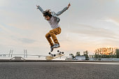 Boy jumping on skateboard at the street.