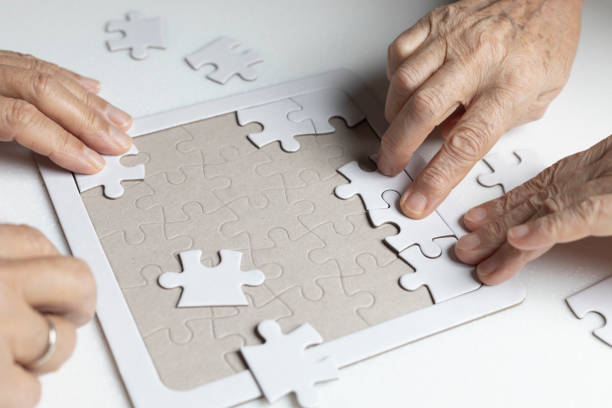 istock Senior Couple is Playing Puzzle. 1183540542
