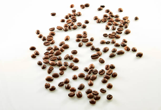 istock Coffee beans scattered isolated on white 1183541759